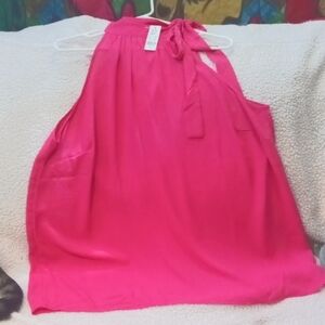 Sleeveless bright pink blouse.